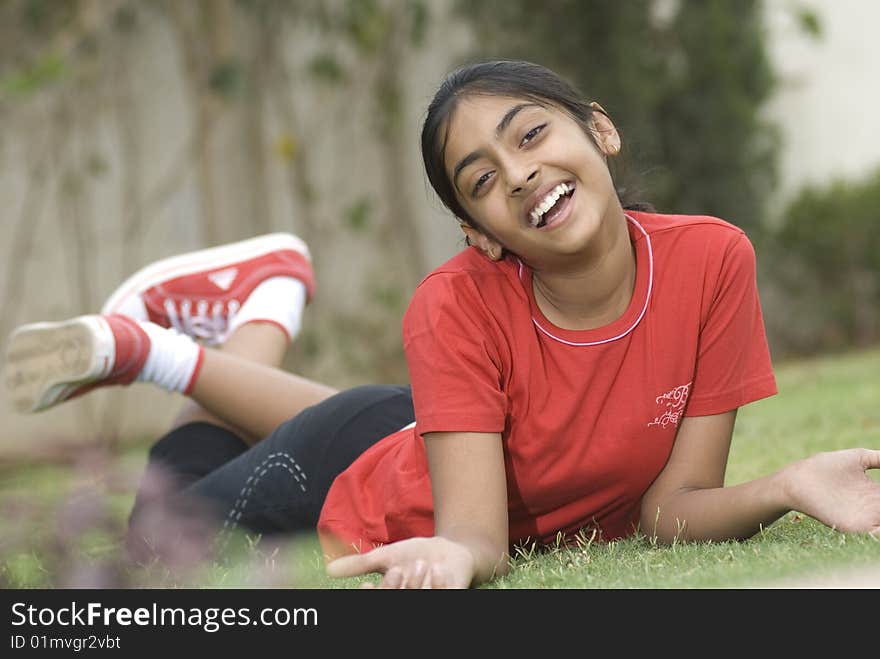 Portrait of beautiful girl lying in garden