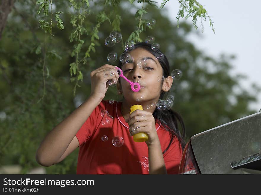 Portrait of beautiful girl blowing bubble