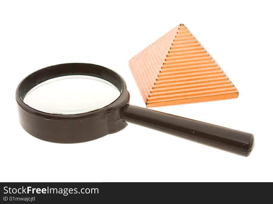 Figure of a yellow pyramid with a magnifier laying nearby. Figure of a yellow pyramid with a magnifier laying nearby