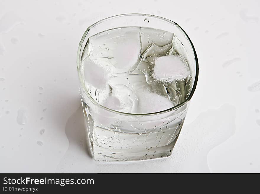 Glass with water and ice slices. Glass with water and ice slices