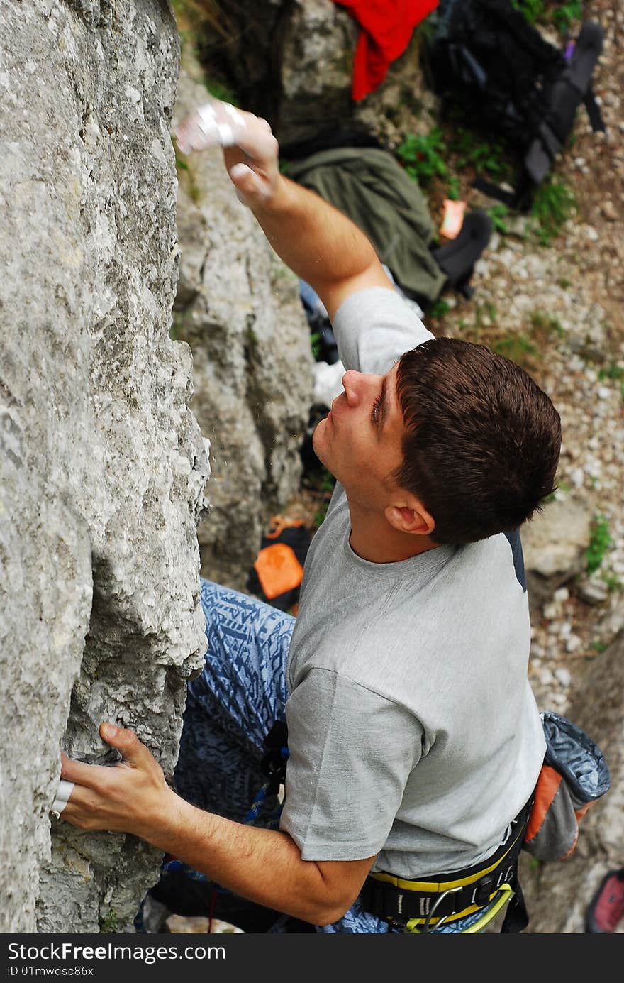 Climber on the wall reaching for the next step. Climber on the wall reaching for the next step