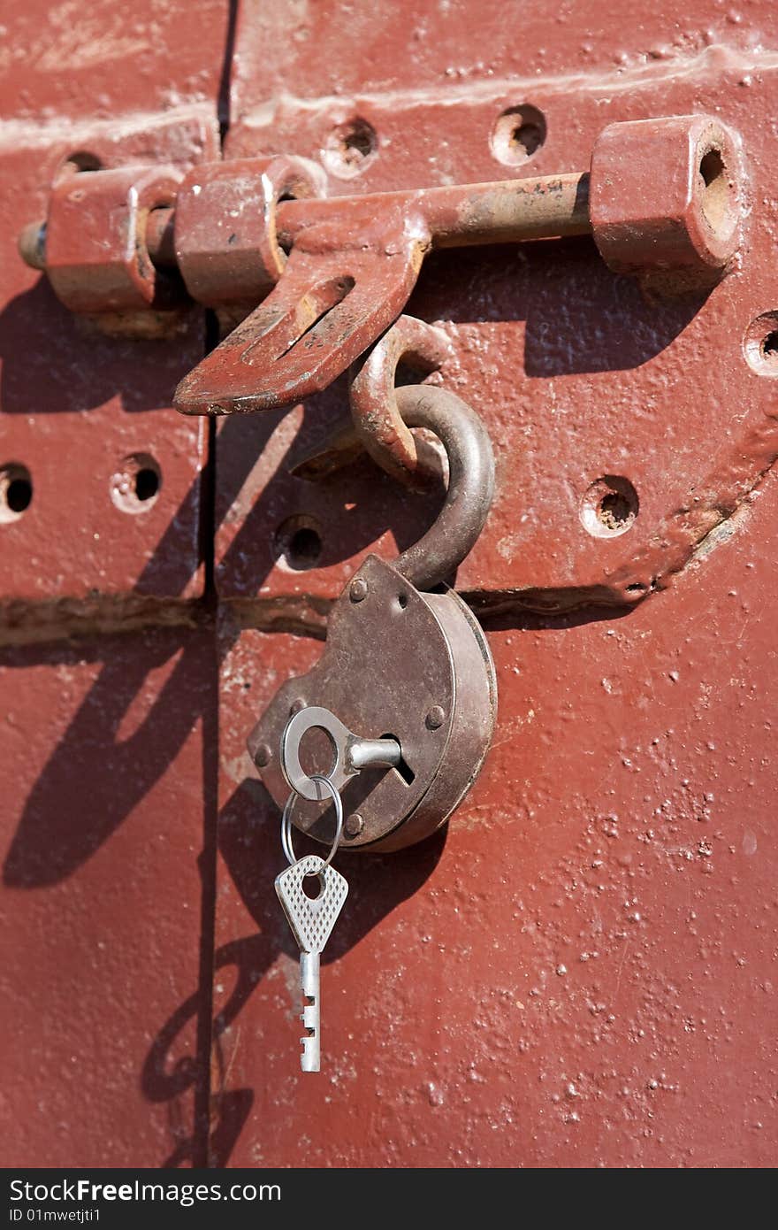 Opened old padlock hanging with keys