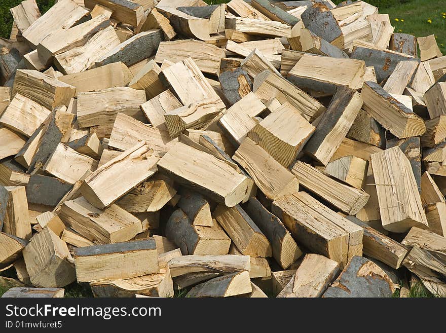 Chopped wood in a woodpile, ready for the wood burning stove