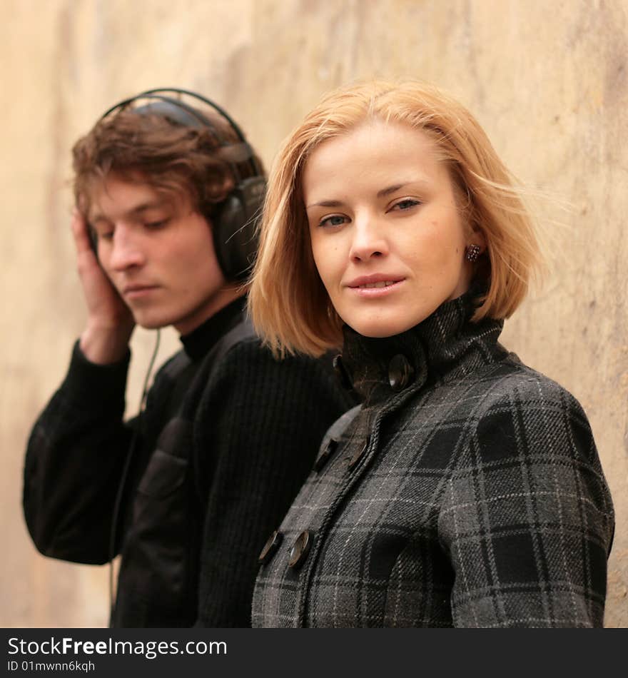 Blonde woman and man is listening to music on the front burner. Blonde woman and man is listening to music on the front burner