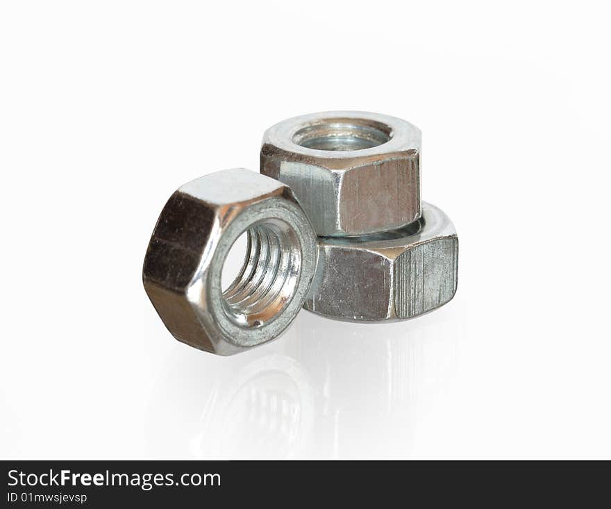 Close-up of three steel screw nuts isolated on white background with clipping path