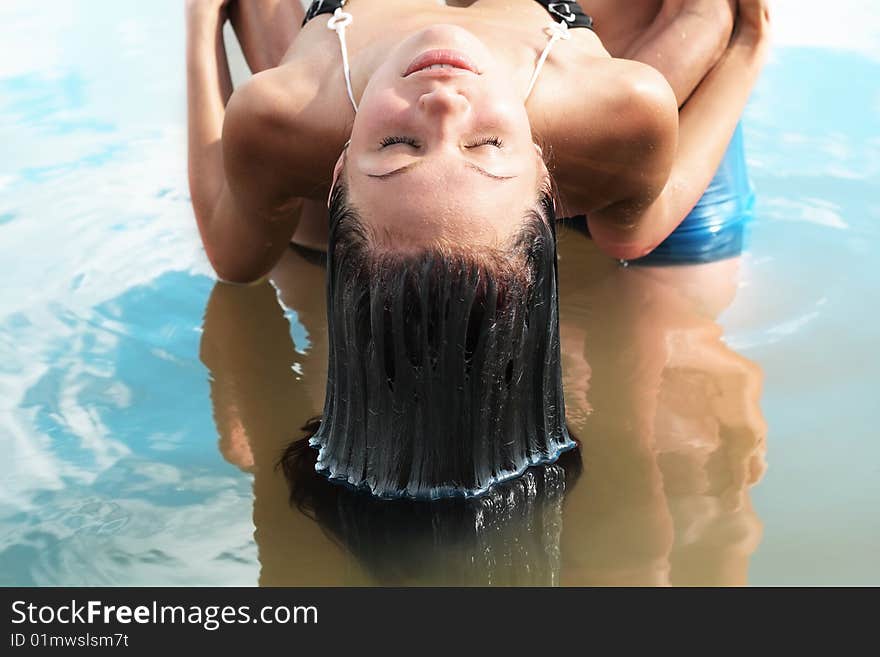 Young woman above the water with wet hair