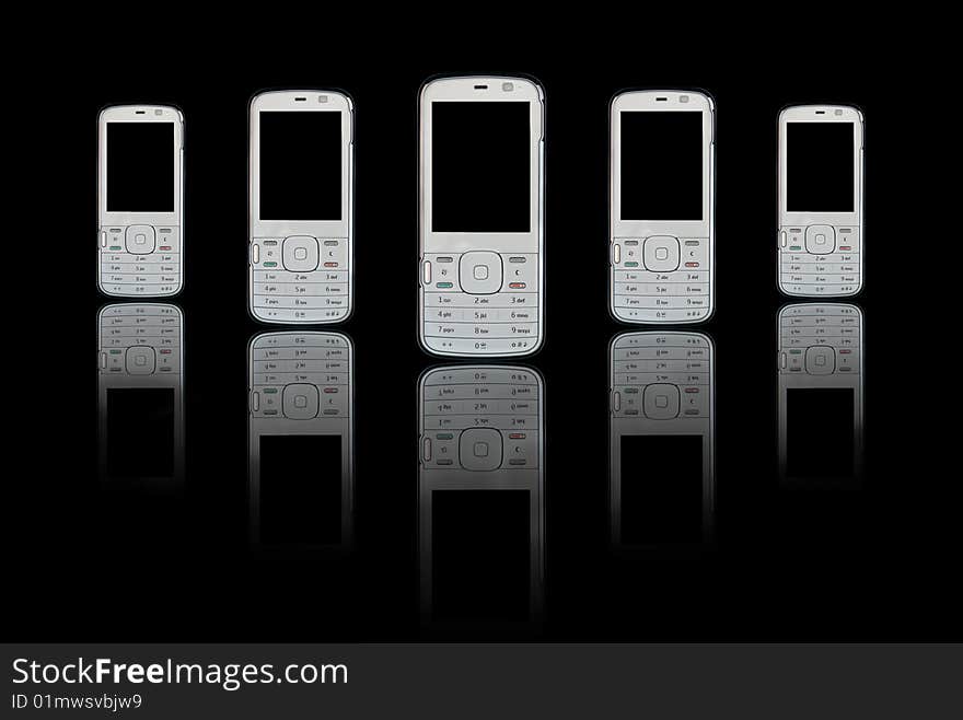 Mobile phones with reflections on black background