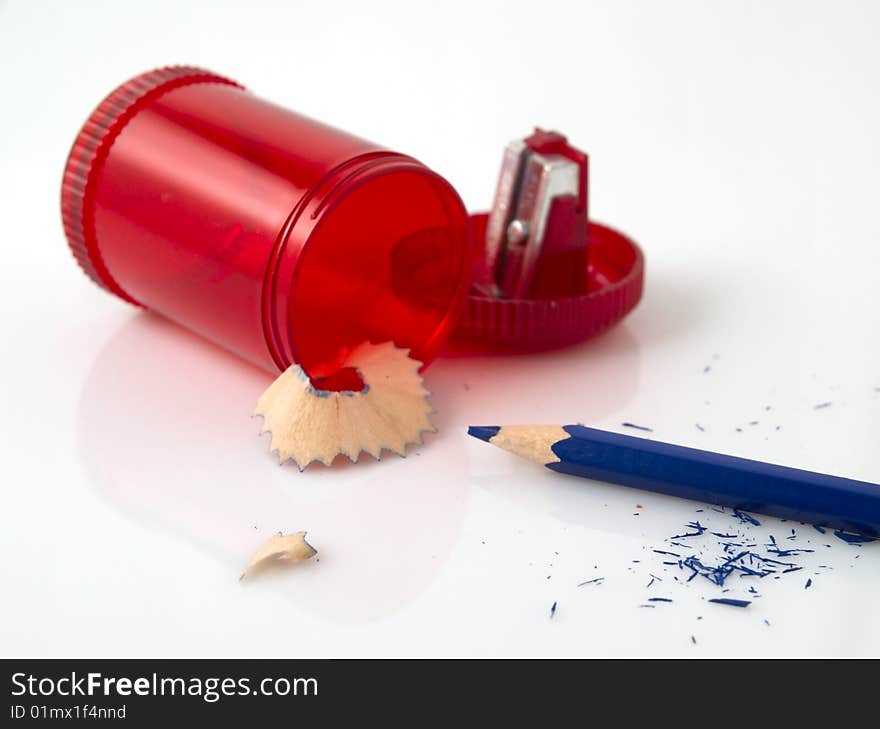 A blue colored crayon with sharpener over white