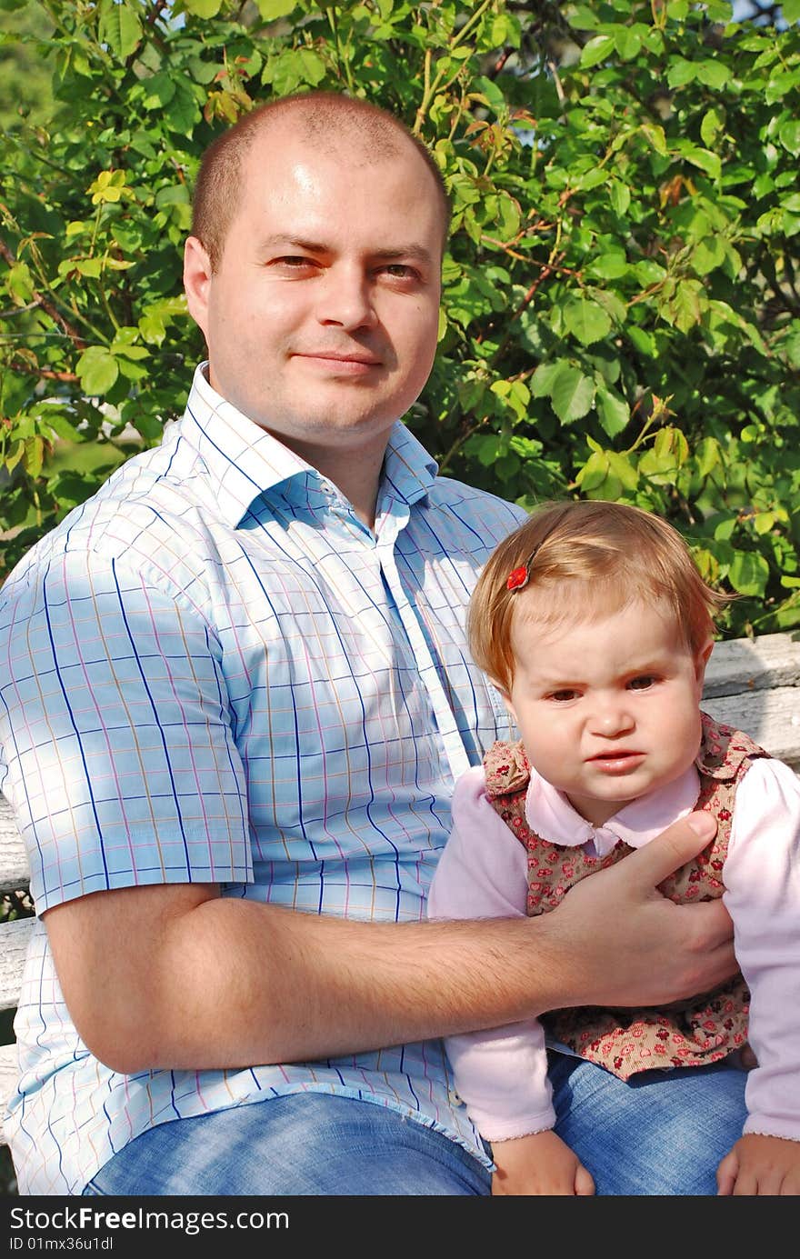 Happy family, dad and daughter  in the park