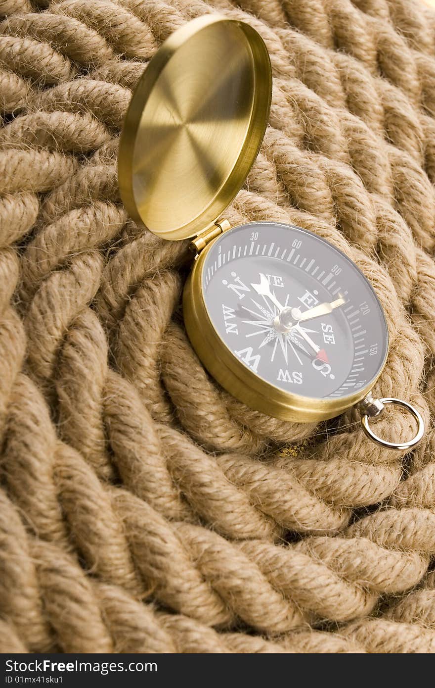 A beautiful golden compass on a rope