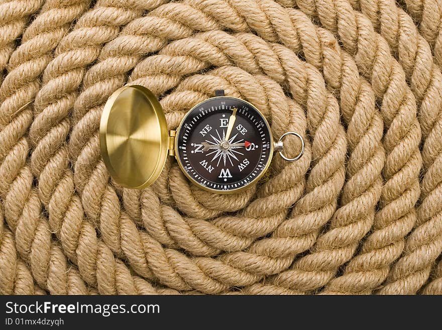 A beautiful golden compass on a rope