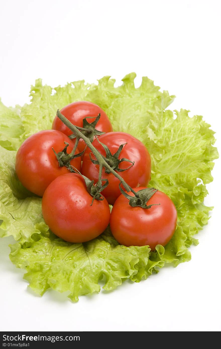 Group red tomato on leaf lettuce. Isolated over white background. Group red tomato on leaf lettuce. Isolated over white background.