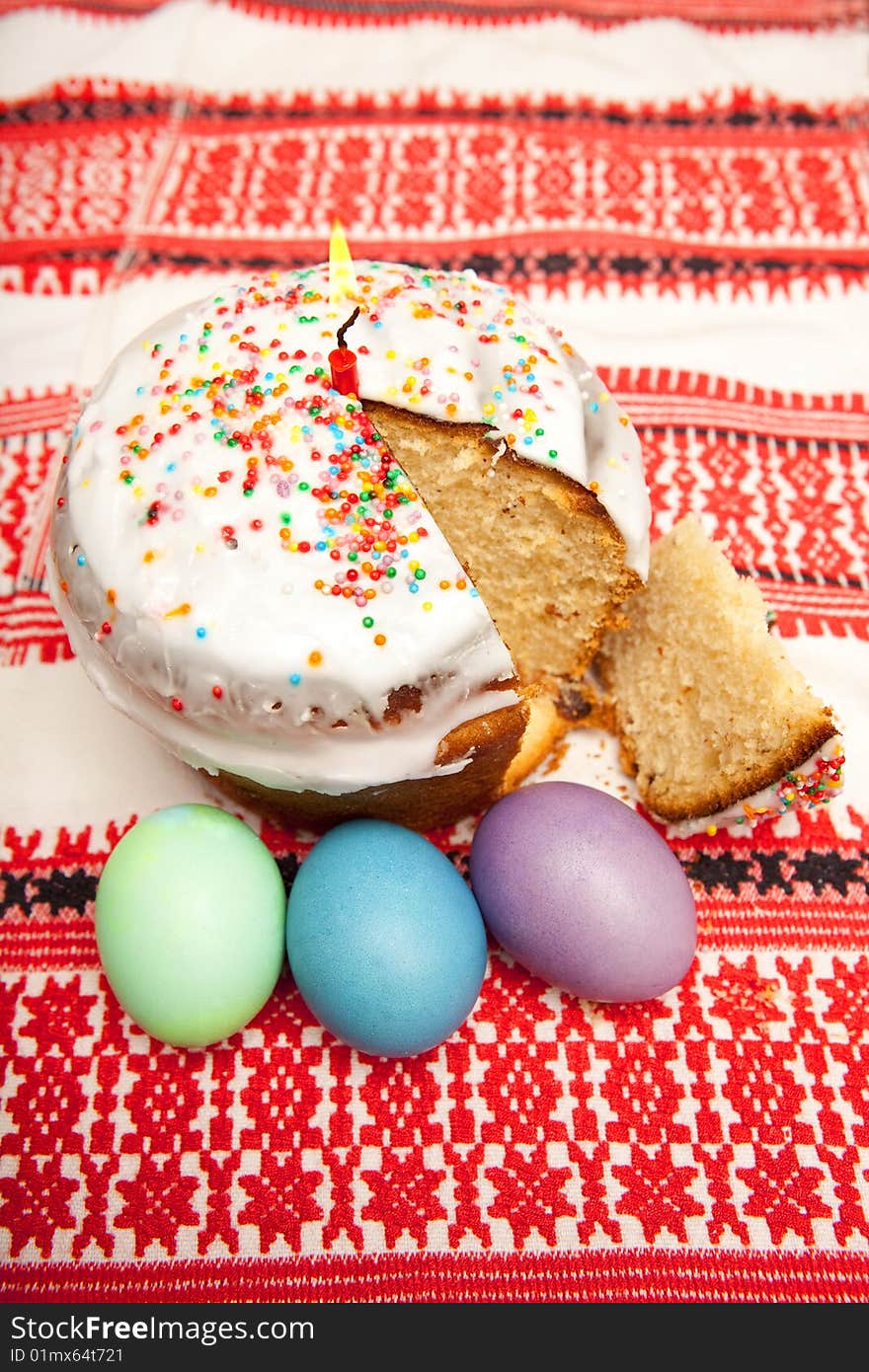 Easter pie with candle and tree eggs on rushnyk