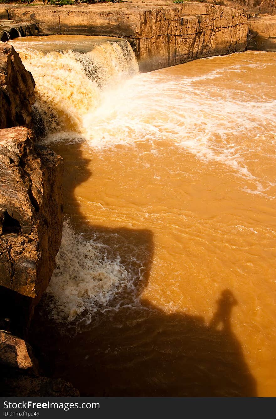 Turbid water of tropical waterfall after hard rain