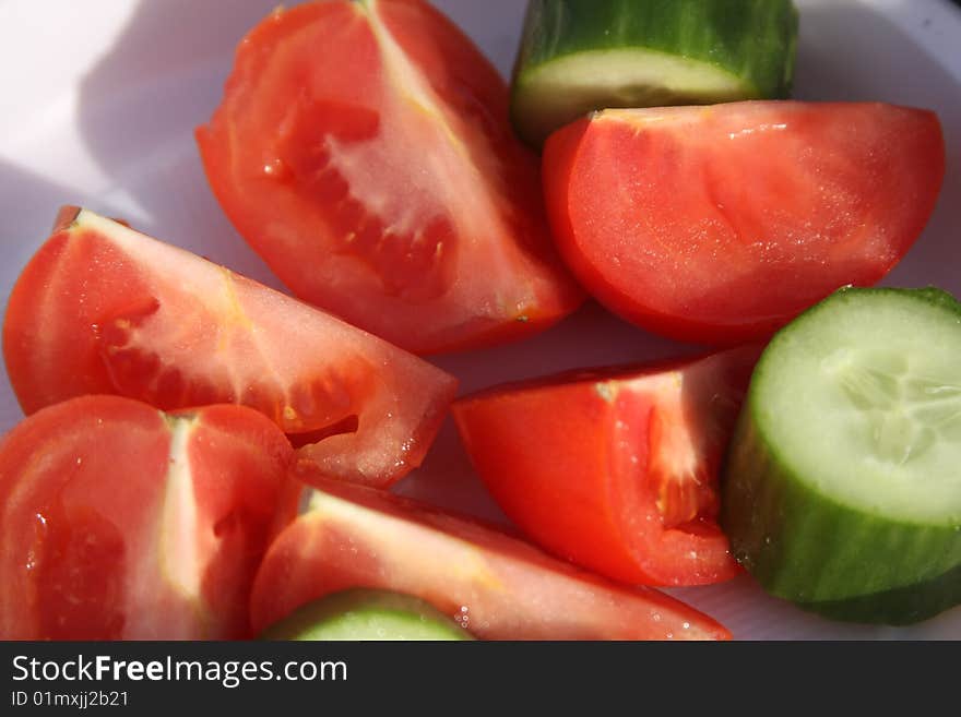 Cucumbers and tomatoes before salad preparation. Cucumbers and tomatoes before salad preparation