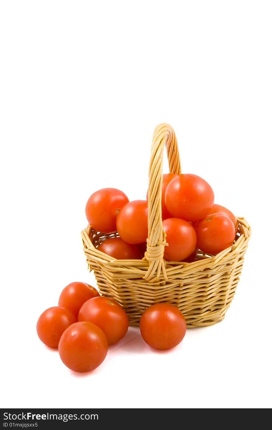 Cherry berr ytomatoes in a wicket isolated on white background