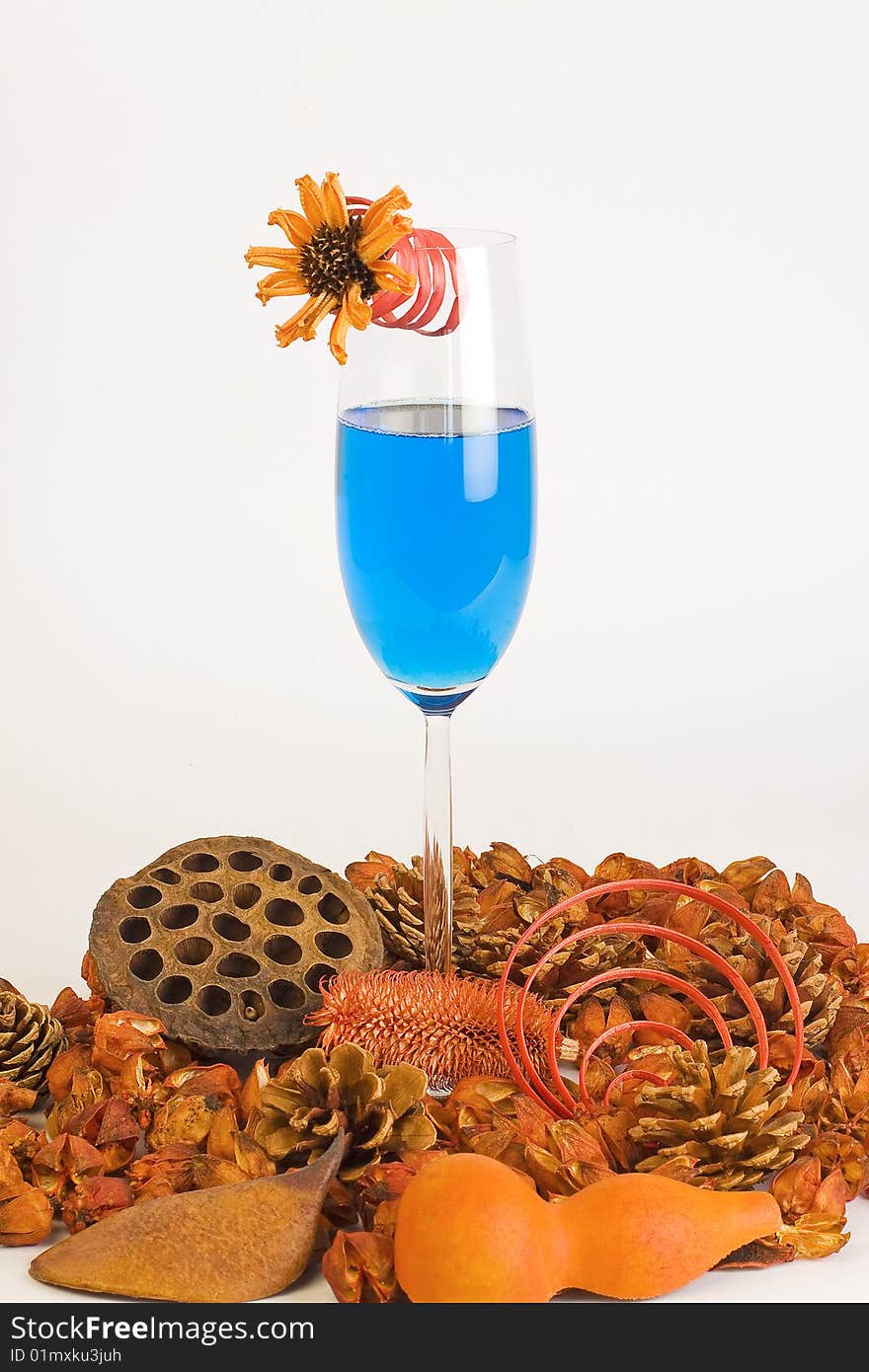 Cocktails blue and composition of dried flowers on a white background. Cocktails blue and composition of dried flowers on a white background