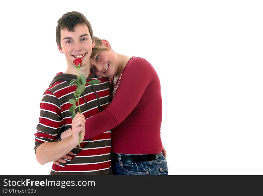 Two casual dressed teenagers , teenage man holding rose flower and woman in love. studio shot. Two casual dressed teenagers , teenage man holding rose flower and woman in love. studio shot.