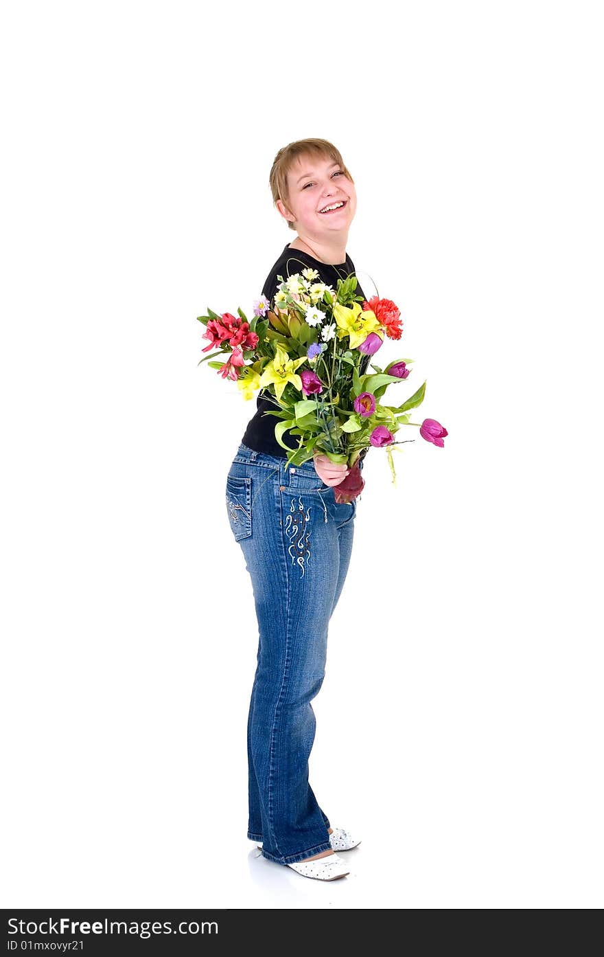 Happy smiling young girl presenting flowers