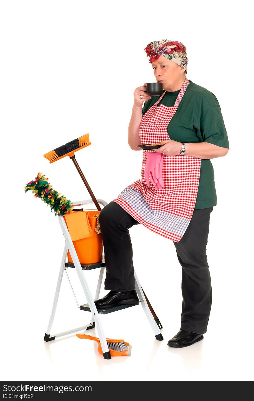 Housewife with cleansing tools doing household, enjoying a cup of coffee. Housewife with cleansing tools doing household, enjoying a cup of coffee