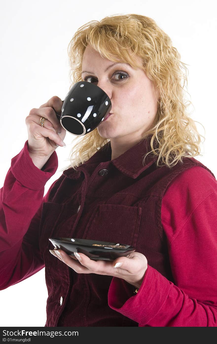 A beautiful woman is drinking coffee out of mugs in black. A beautiful woman is drinking coffee out of mugs in black