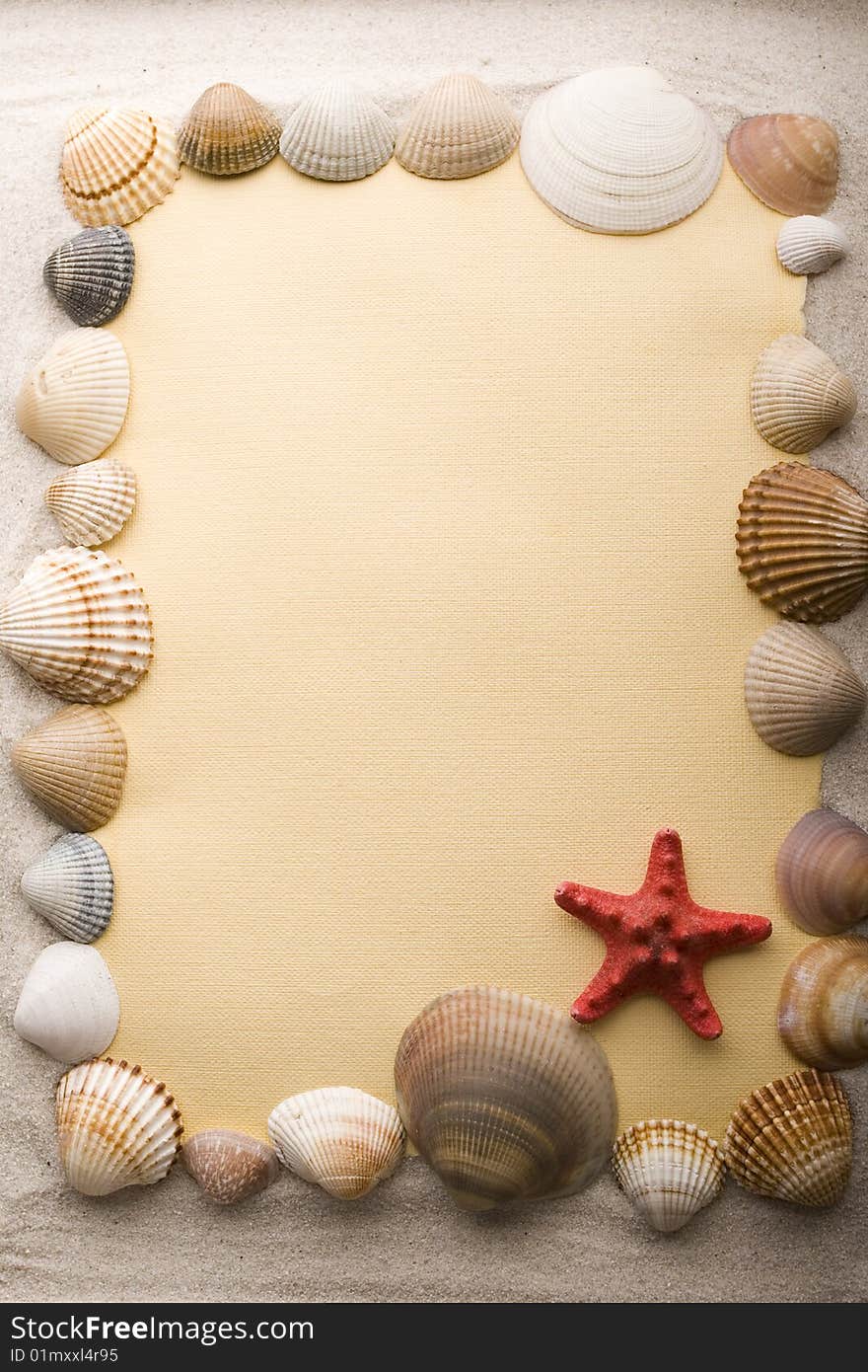 A beautiful yellow letter with shells on sand. A beautiful yellow letter with shells on sand