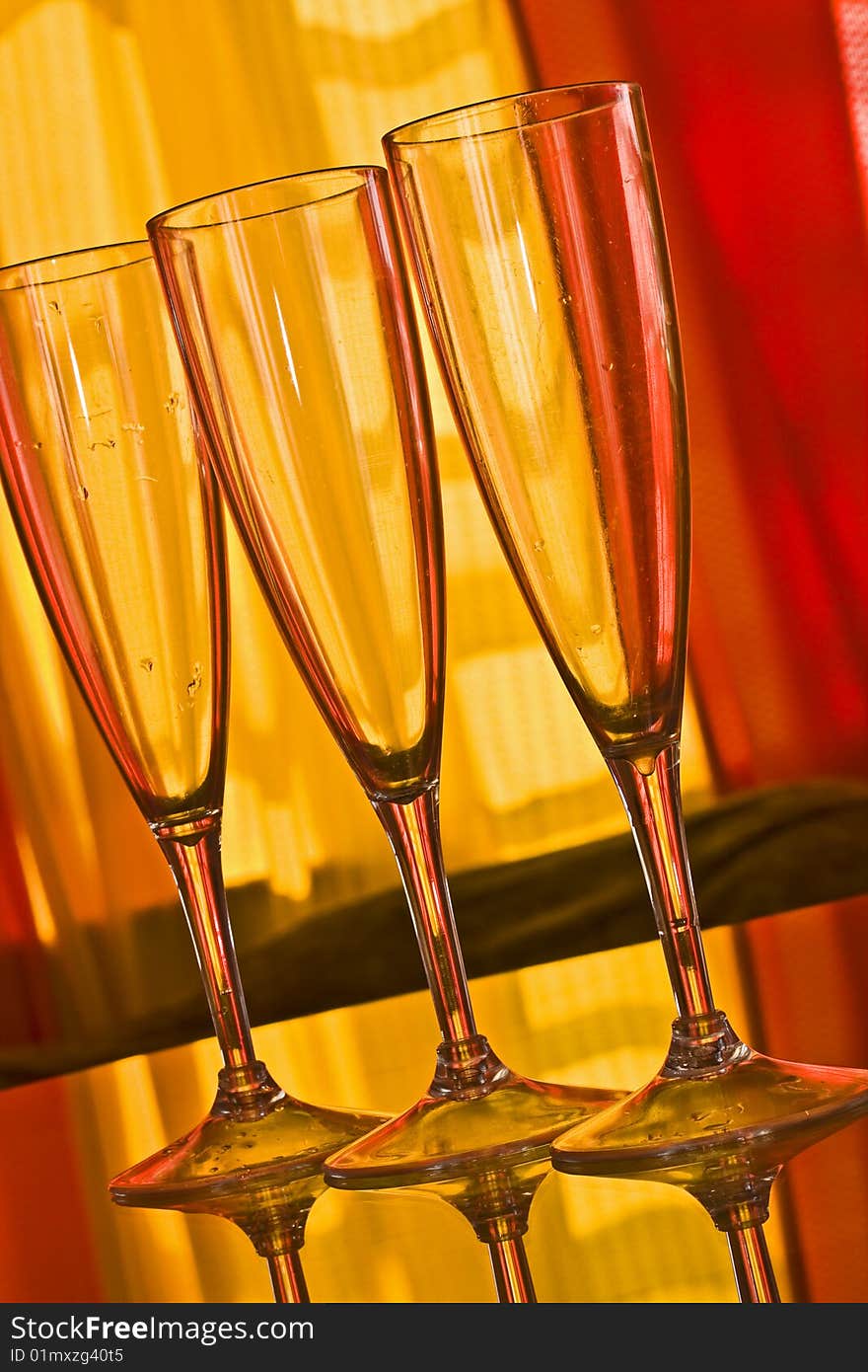 Champagne glass with yellow and orange background. Champagne glass with yellow and orange background