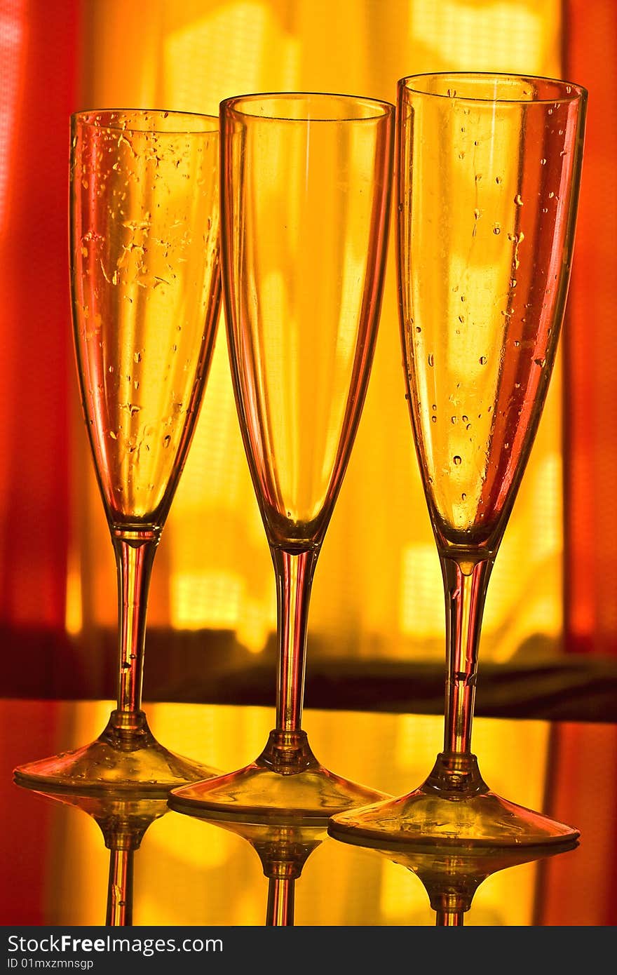 Champagne glass with yellow and orange background. Champagne glass with yellow and orange background