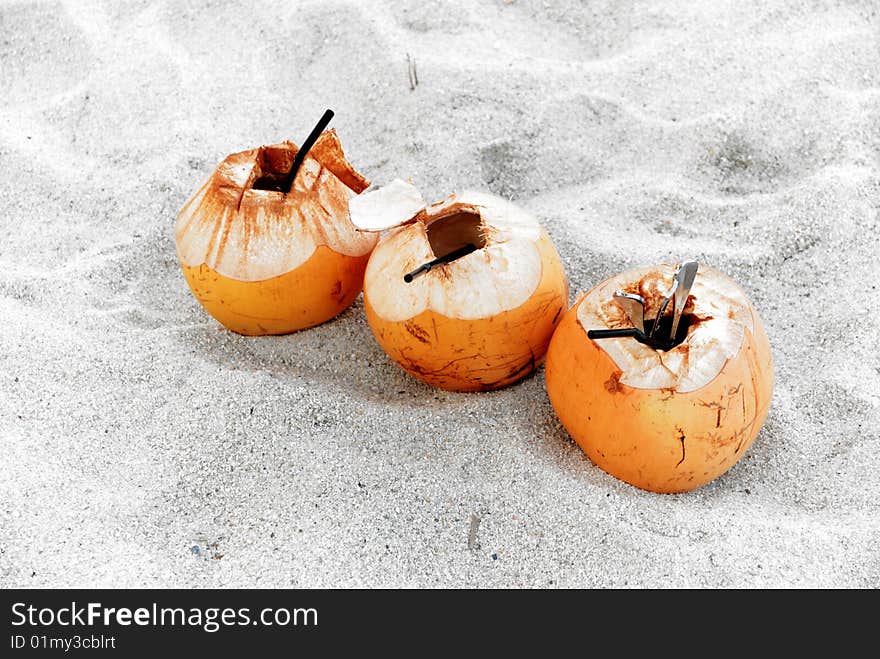 Three fresh coconut drink leave on beach