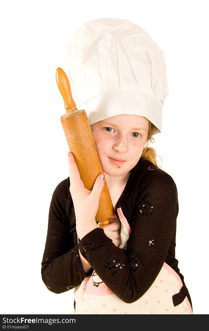 Cook wearing a chefs hat is holding a rolling pin