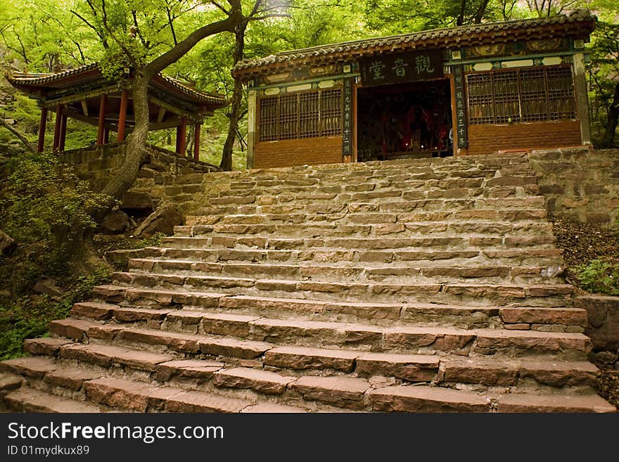 Cangyanshan, Hebei province, China. An ancient pavilion clustered against the natural stonewall. Cangyanshan, Hebei province, China. An ancient pavilion clustered against the natural stonewall.