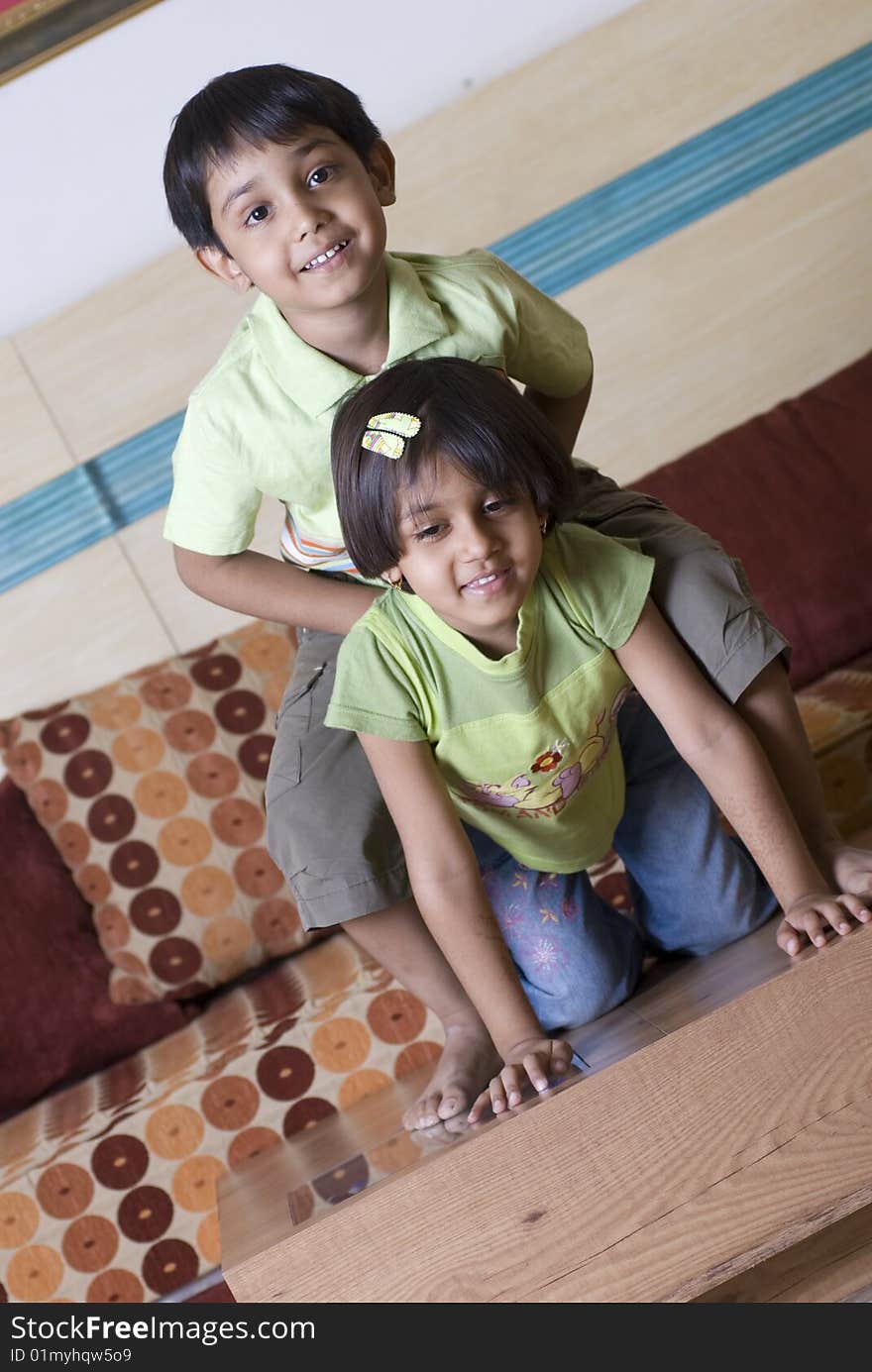 Brother goofing around sister at home. Brother goofing around sister at home