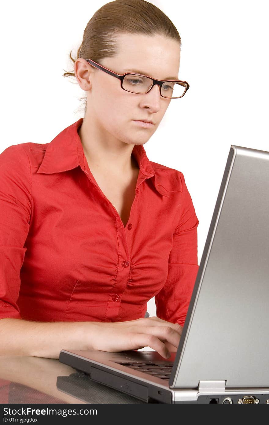 Young woman working on laptop on white ground