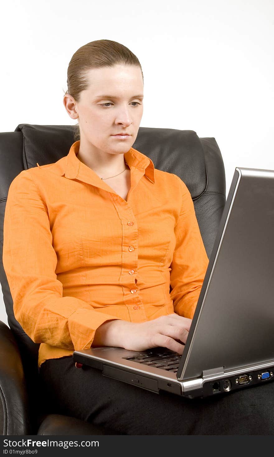 Young woman working on laptop on white ground