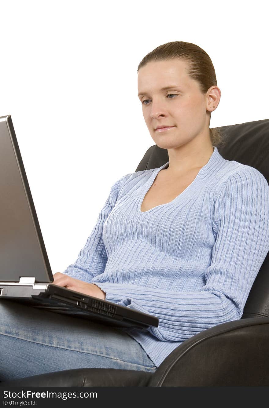 Young woman working on laptop on white ground