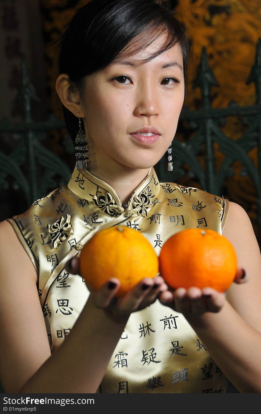 Beautiful Asian Woman Holding Oranges