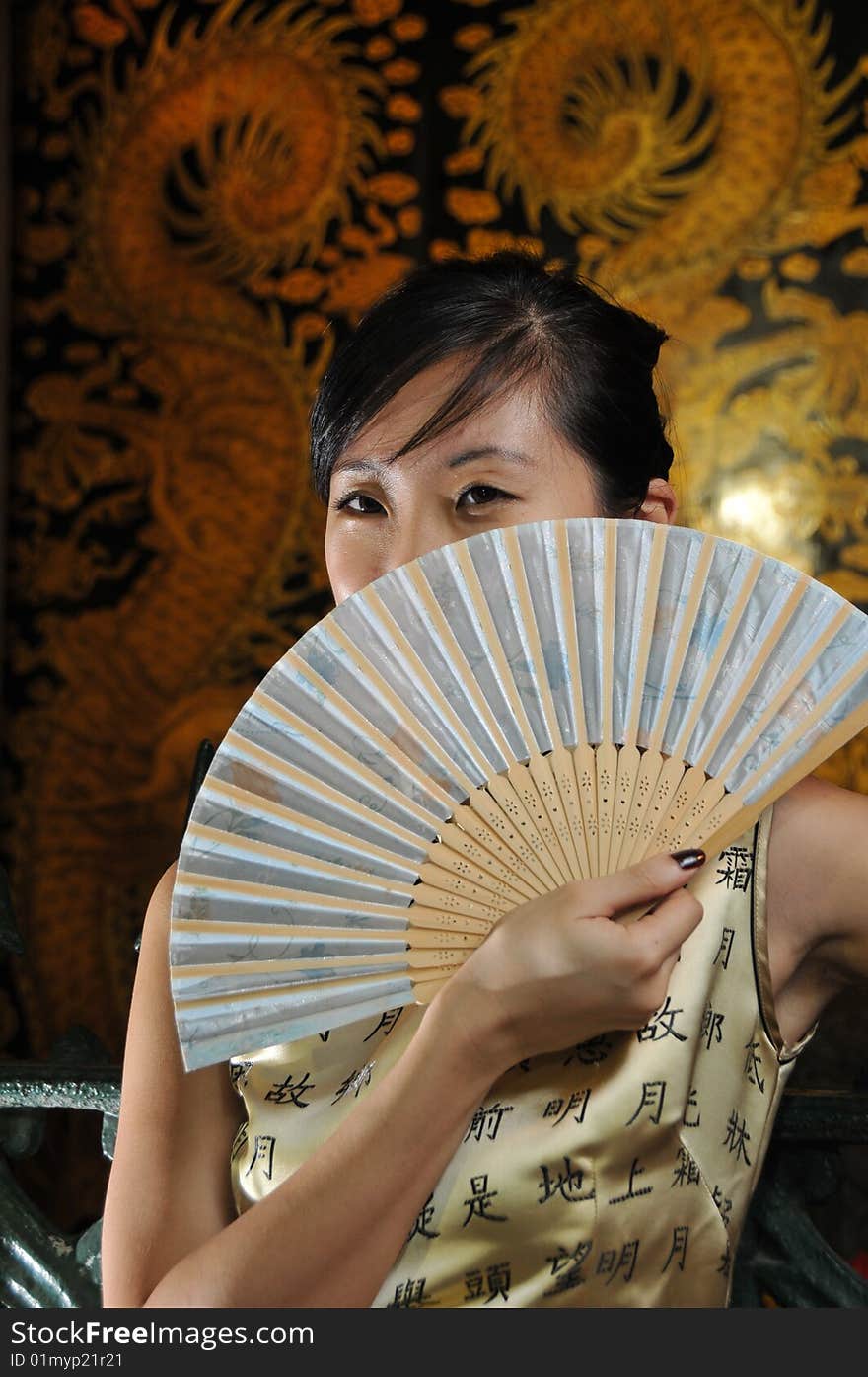 Beautiful Asian Woman In Oriental Theme Holding A Fan.