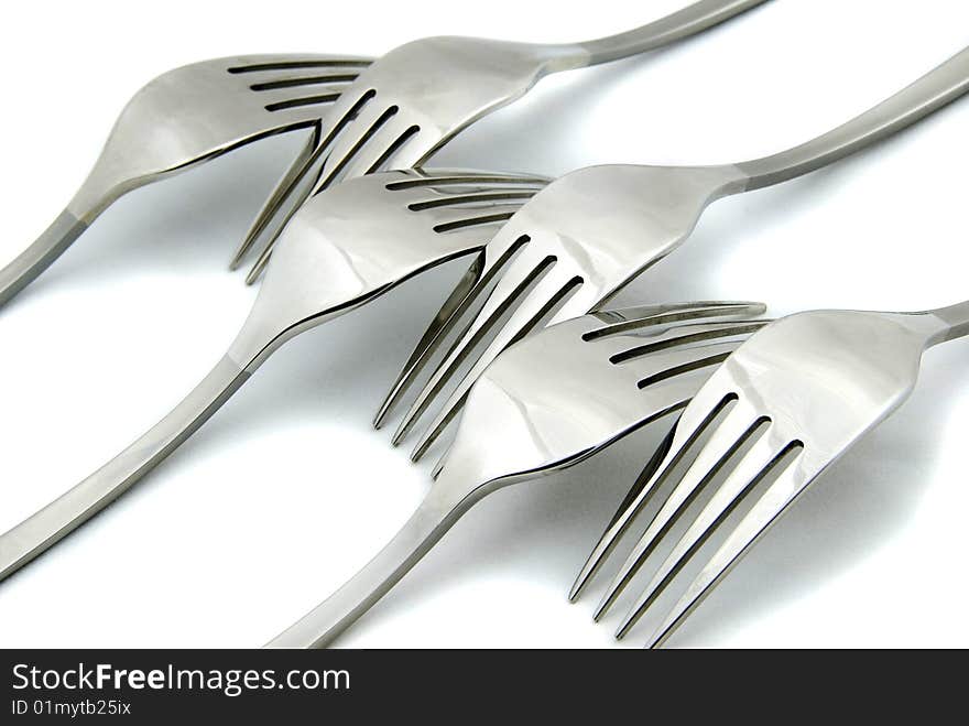 Metallic forks on white background