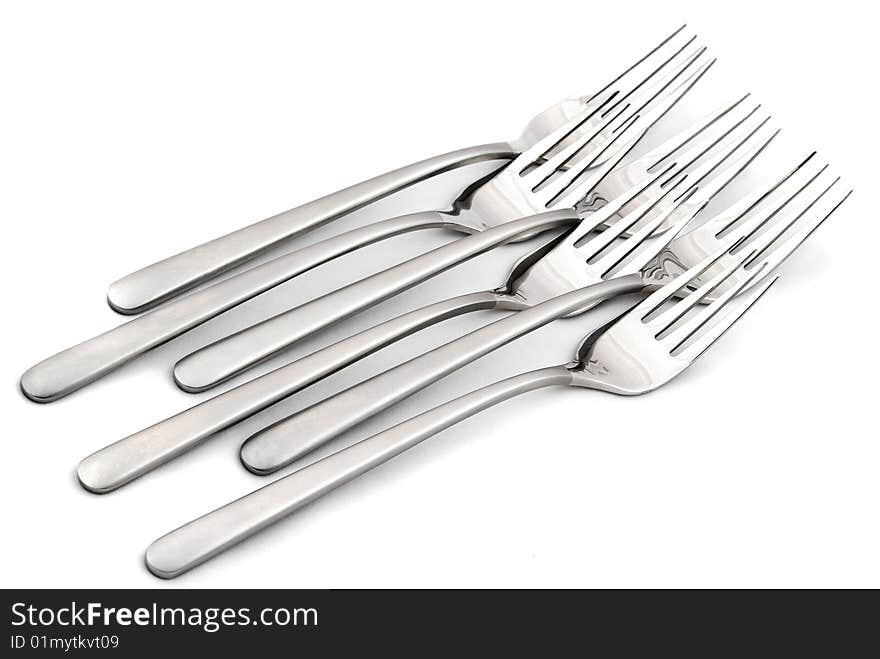 Metallic forks on white background