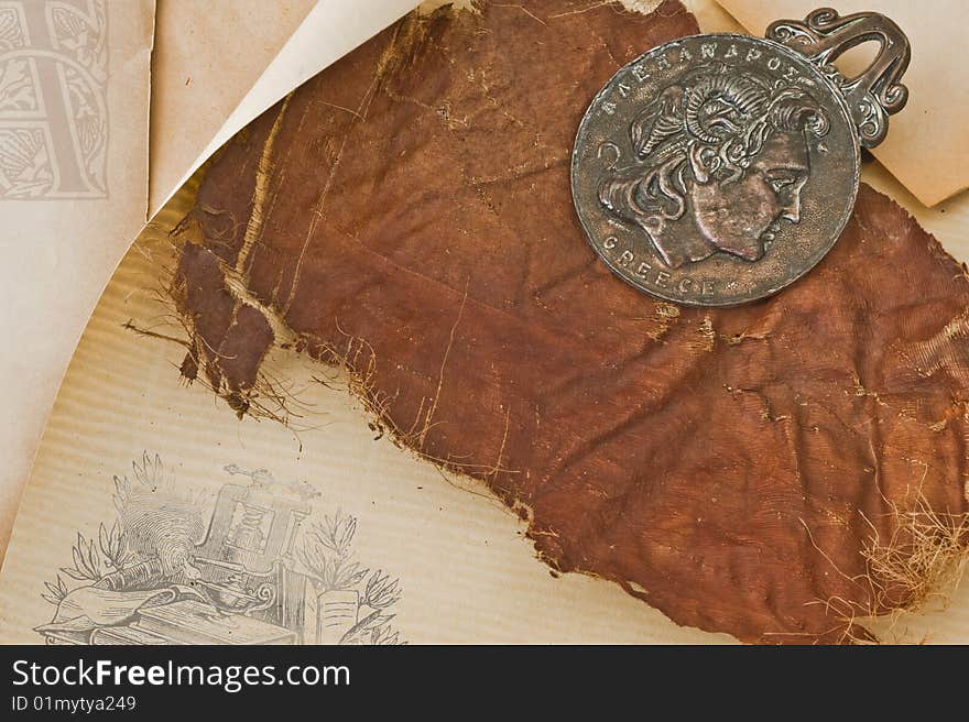 Ornamental background with old paper and ancient holder for a paper. Ornamental background with old paper and ancient holder for a paper