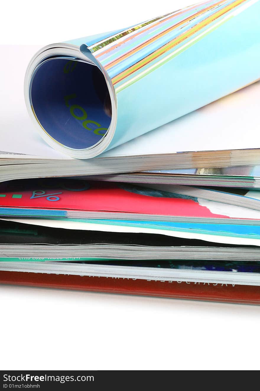 A pile of magazines on white background