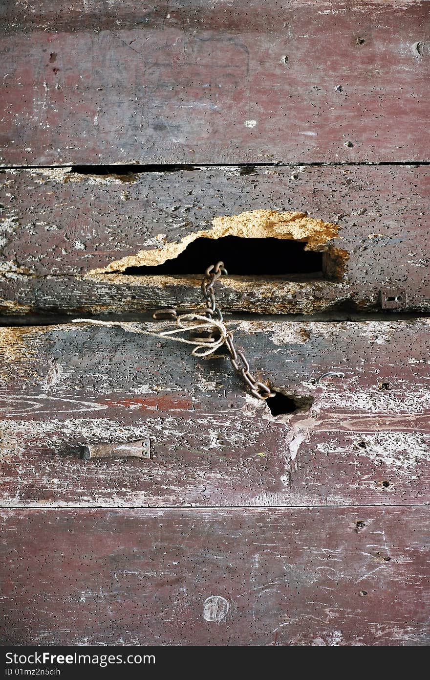 Background from old half-rotten ship boards, are fastened among themselves by a rusty chain. Background from old half-rotten ship boards, are fastened among themselves by a rusty chain