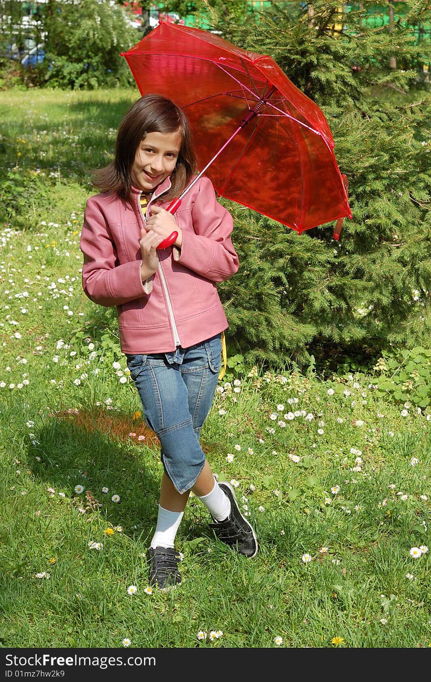 Little girl with a red umbrella having fun in park. Little girl with a red umbrella having fun in park