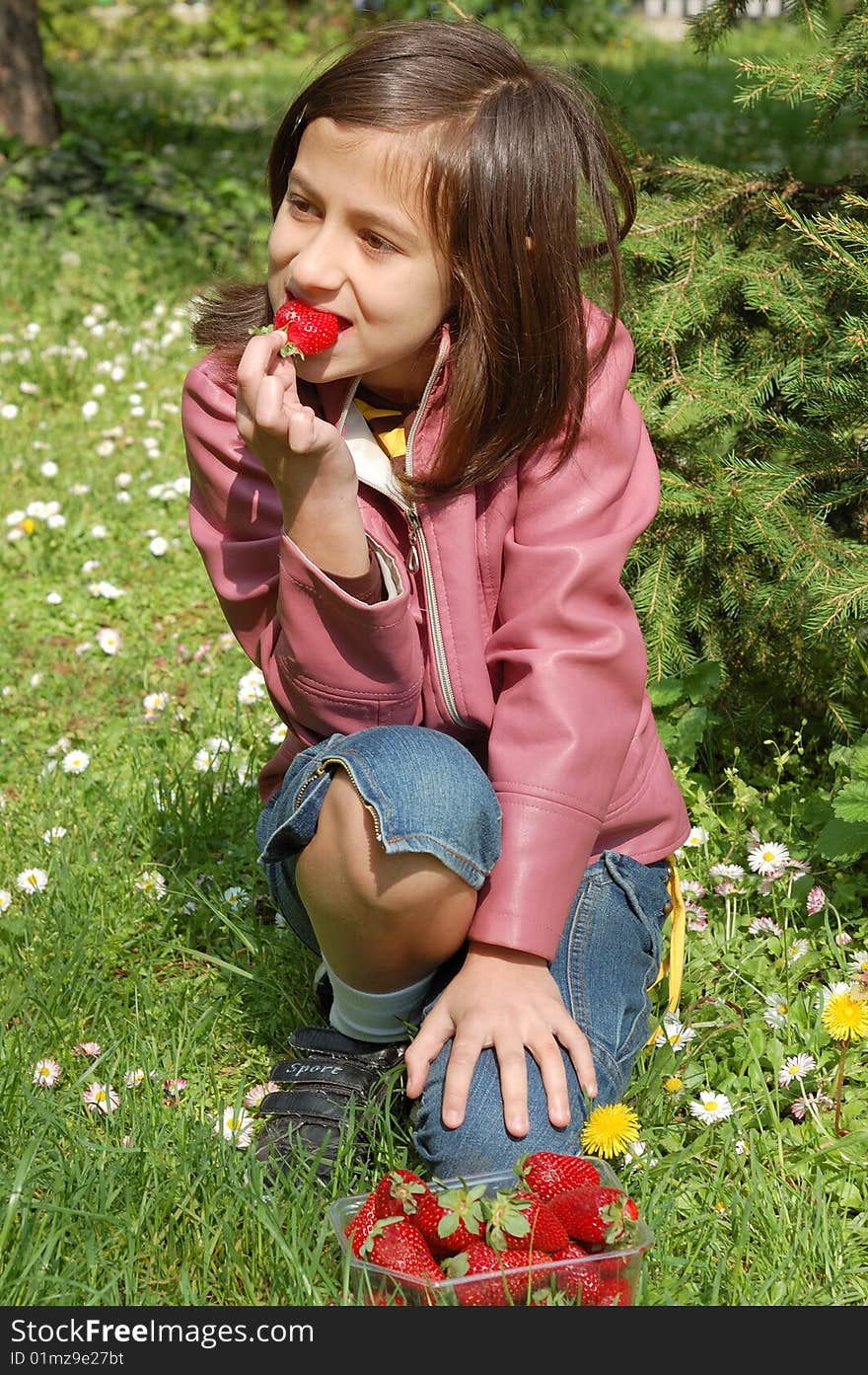 Happy young girl holding strawberries. Happy young girl holding strawberries.