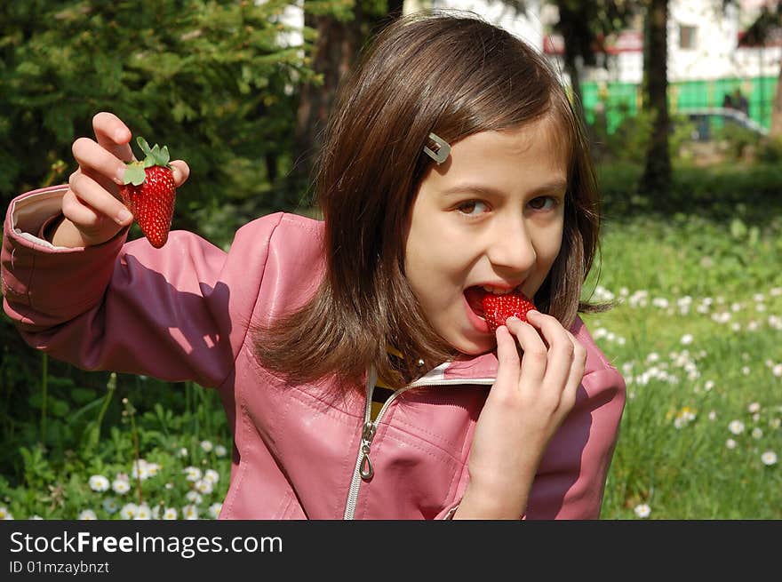 Happy young girl holding strawberries. Happy young girl holding strawberries.