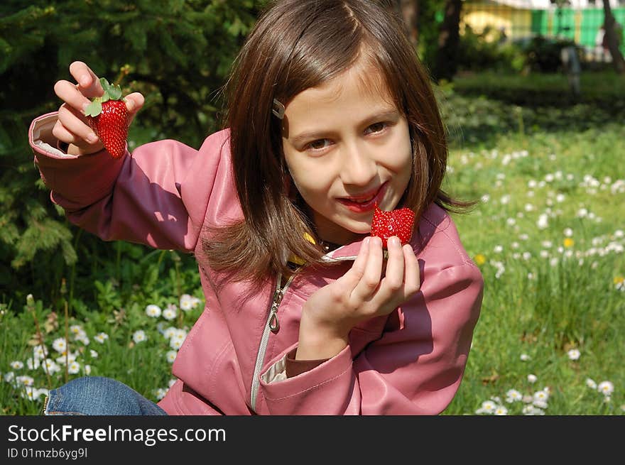 Happy young girl holding strawberries. Happy young girl holding strawberries.