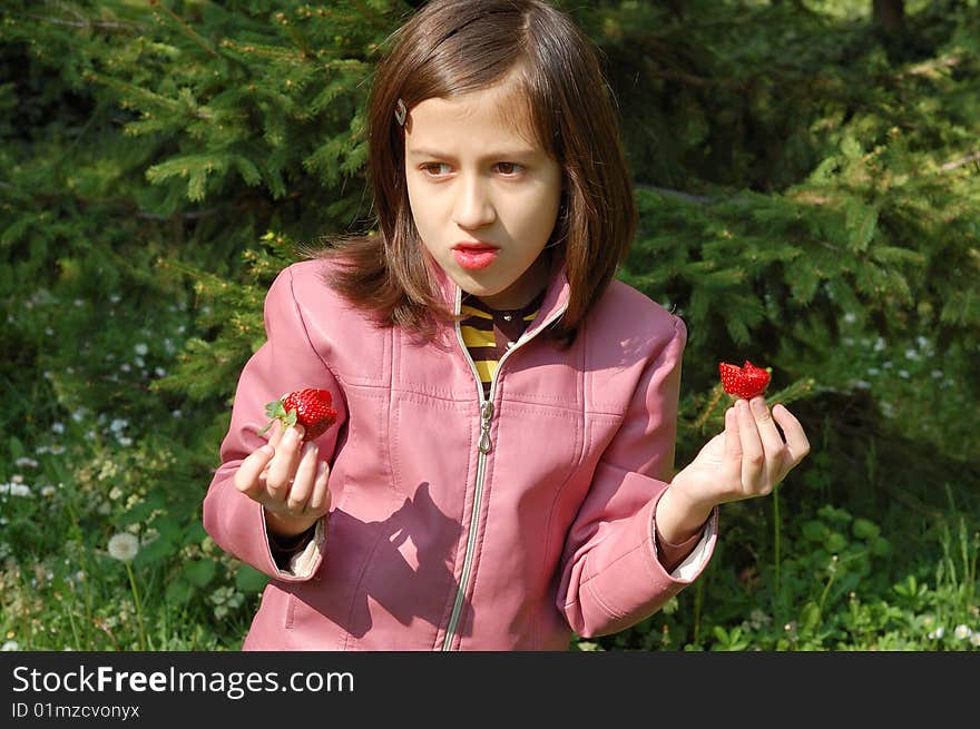 Happy young girl holding strawberries. Happy young girl holding strawberries.