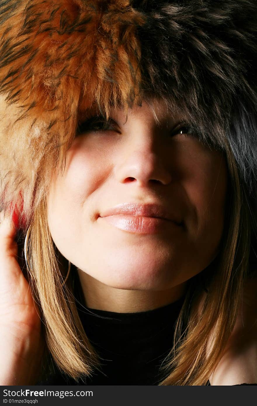 Portrait of a beautiful girl in a fur hat