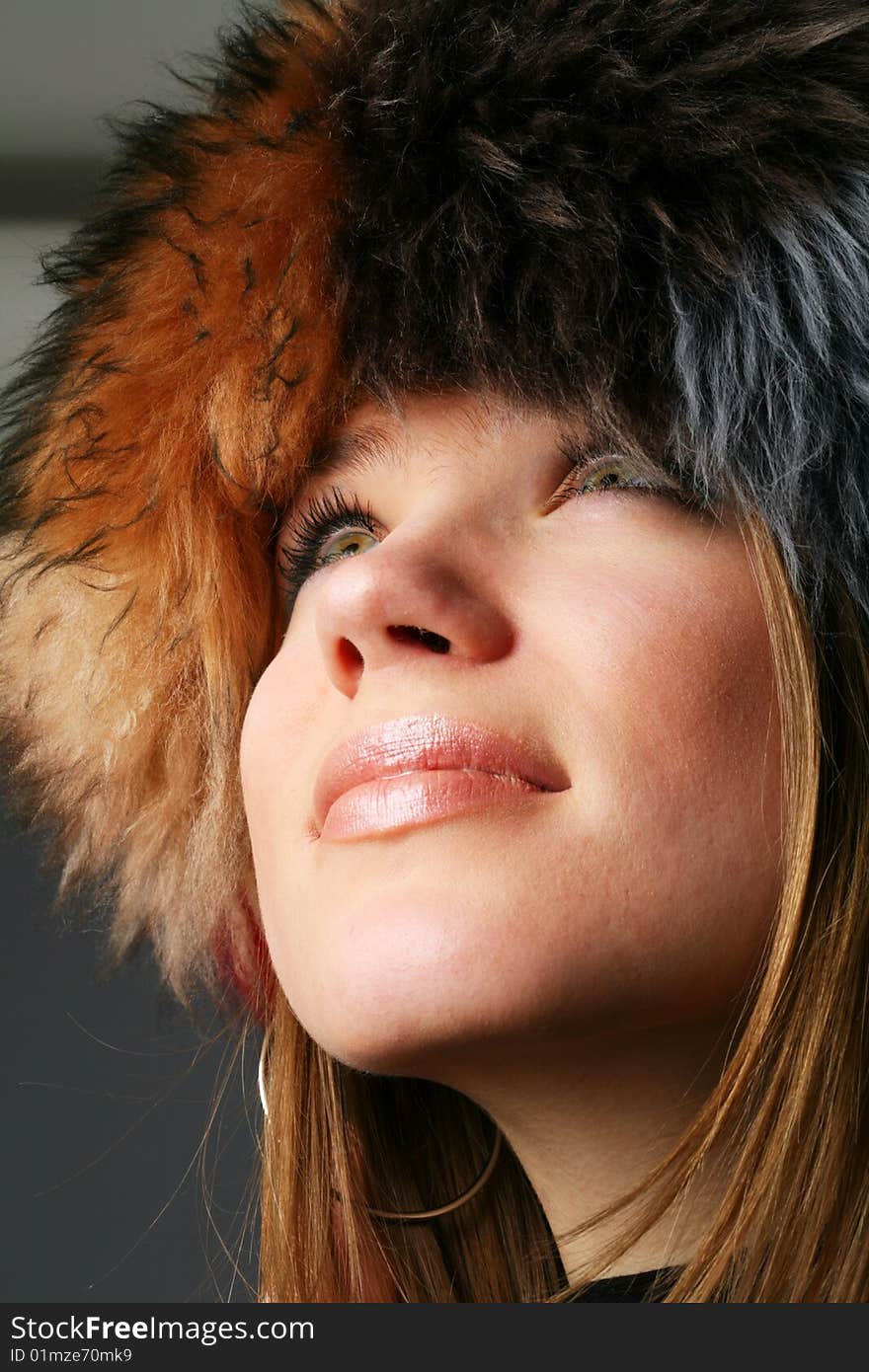 Portrait of a beautiful girl in a fur hat