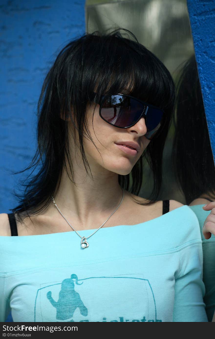 Girl in a blue T-shirt and glasses. Girl in a blue T-shirt and glasses